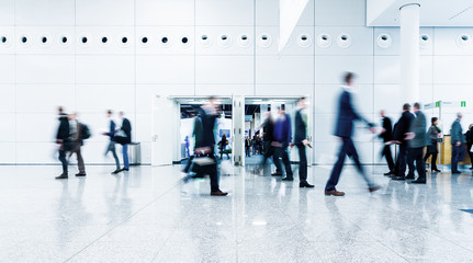 blurred business people trade fair stock photo
