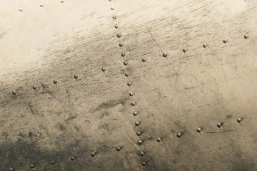 Old rasty metal surface of the aircraft fuselage with rivets