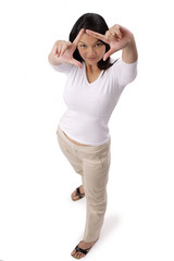 Fototapeta premium Woman looking at camera through finger frame