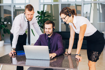 Sales assistants working with computers in an office