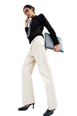 Business woman using mobile phone, carrying folder, looking at camera, low angle view