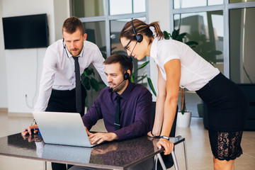Sales assistants working with computers in an office