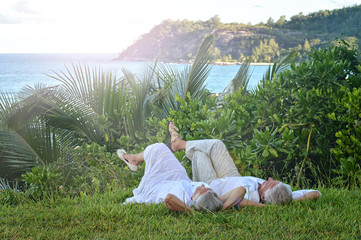 elderly couple rest at tropical beach