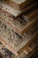 Stacked boards with wood dust