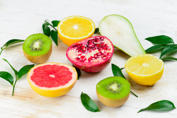 sliced fruit on wooden white backgroun