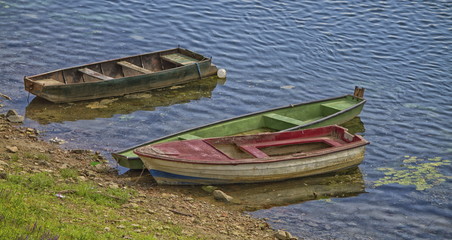 Three old boats along the river