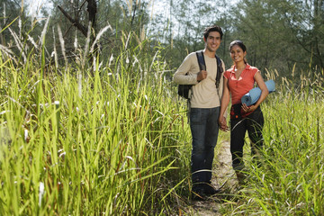 Naklejka na ściany i meble Young couple hiking in the wilderness