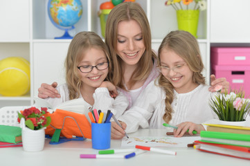 girls  with mother on lesson of art