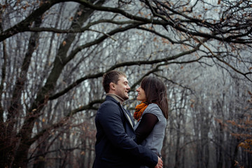 Fototapeta na wymiar happy couple spend free time in autumn wood
