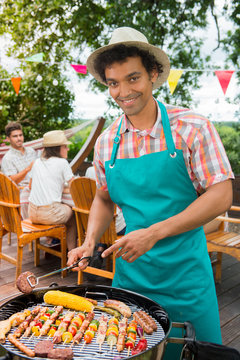 Man happy during a barbecue at family garden BBQ