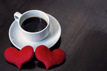 cup coffee and red heart on wood
