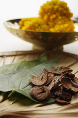 betel nut and leaves with chrysanthemums in background
