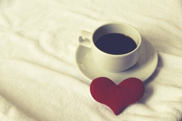 Cup coffee of heart love on white towel floor drink coffee in love
