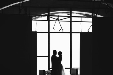 man and woman standing in the background of a window