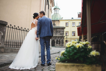 Fototapeta premium the groom and his beloved wife walking in the large city