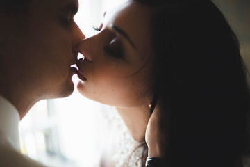 charming bride kissing her husband in lips