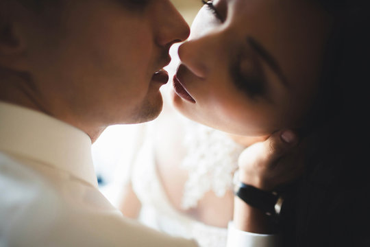 wonderful  bride kissing her husband in lips