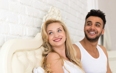 Young Couple Lying In Bed, Happy Smile Hispanic Man And Woman Looking Up To Copy Space Lovers In Bedroom