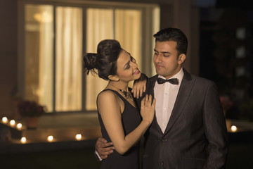 Man and woman in evening wear embracing