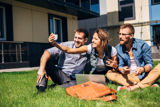 Group of happy friends taking a selfie on  blue sky in campus lawn, caucasian