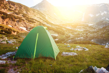 Camping green tent on the grass