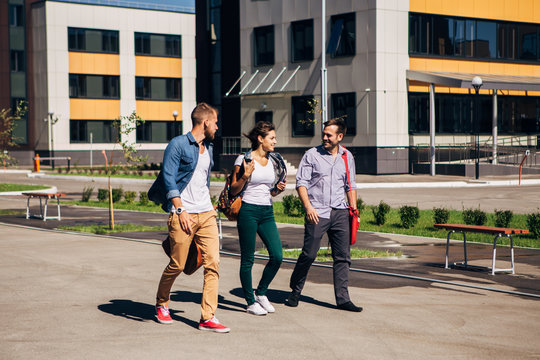 Young Students Walking Outside Campus Building