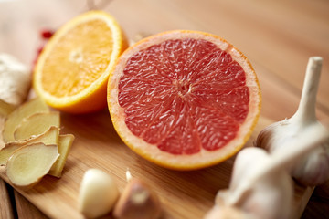 Fototapeta na wymiar citrus fruits, ginger and garlic on wood
