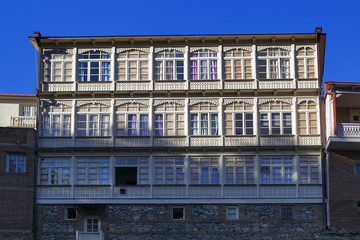 Fototapeta na wymiar Traditional georgian architecture with wooden balconies in Abanotubani historical part of Tbilisi near waterfall in botanical garden.Georgia, unesco heritage