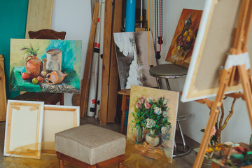 Woman artist painting a picture in a studio