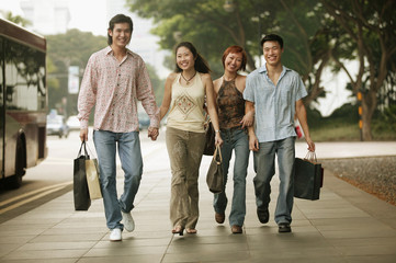Fototapeta premium Couples walking together, carrying shopping bags