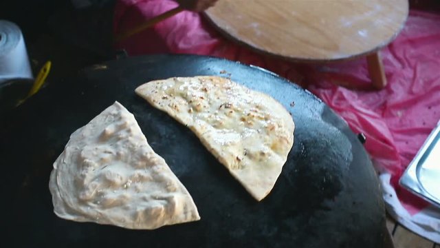Granny chef cook Turkish pancake Gozleme on the stove