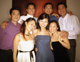 Obraz premium Group of friends posing for a picture, looking at camera