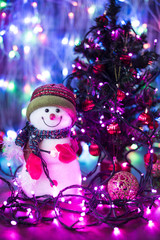Christmas composition with smiling snowman. Christmas funny decorative snowmen on wooden board on lights background Christmas with copy space