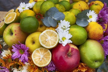 Autumn composition decorating the counter. Apples, quinces and lemons, together with eucalyptus and daisies on the table