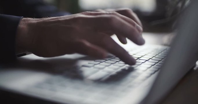 Man typing on computer keyboard