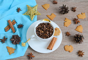 Cup of coffee beans with christmas decorations on wooden table
