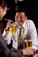 Two men drinking beer.