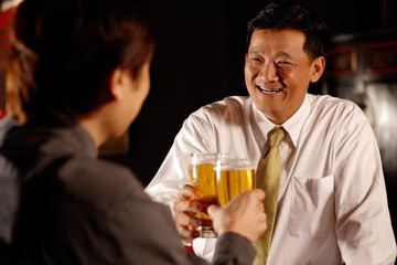 Two men toasting with beer.