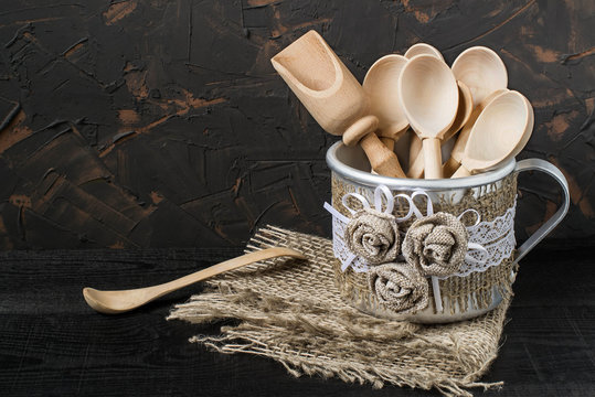 Spoon in a mug with handmade decor of burlap and lace