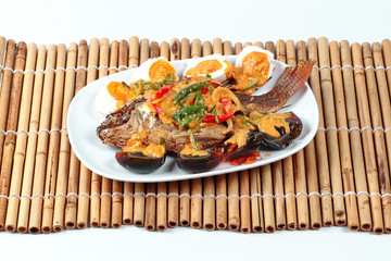 Curry-fried  tilapia fish with preserved egg and salted egg.