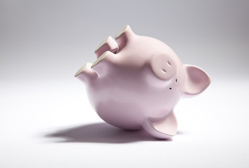 Pink piggy bank upside down.