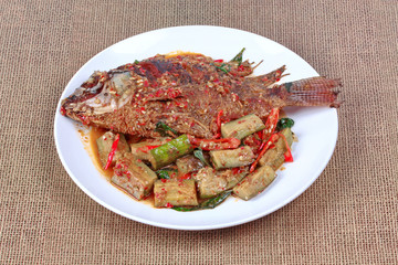 Deep-fried tilapia fish topped Spicy fried eggplant.