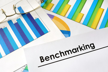 Paper with words Benchmarking and charts.