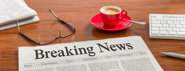 A newspaper on a wooden desk - Breaking News