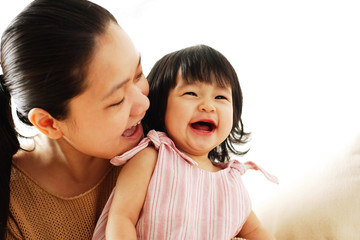 Mother and baby girl, smiling