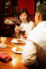 Couple holding wine glasses at restaurant
