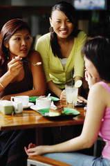 Fototapeta na wymiar Young women eating at cafe