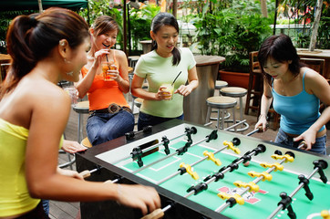 Young women playing foosball
