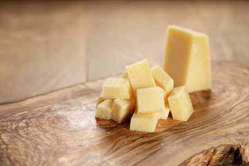 parmesan cubes on olive wooden board