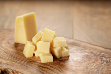 parmesan cubes on olive wooden board